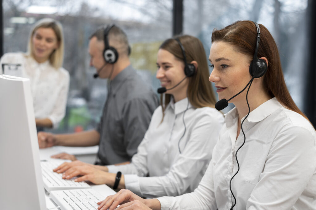 colleagues-working-together-call-center-with-headphones